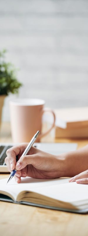 Hands of business lady writing schedule for the upcoming week